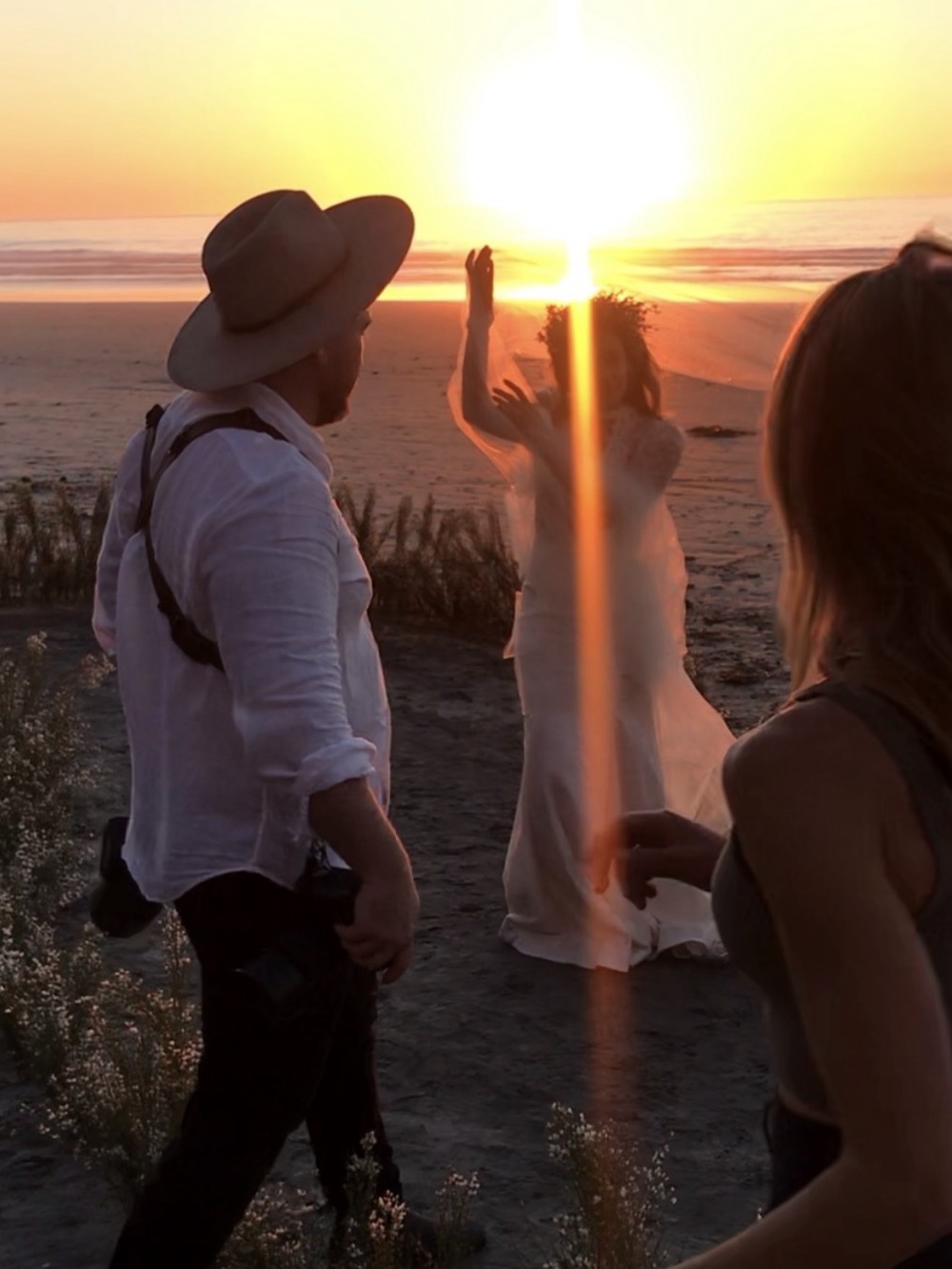 Paul Von Rieter directing a bride at golden hour on the beach